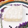 Brie (Cheese) on a plate with purple flowers