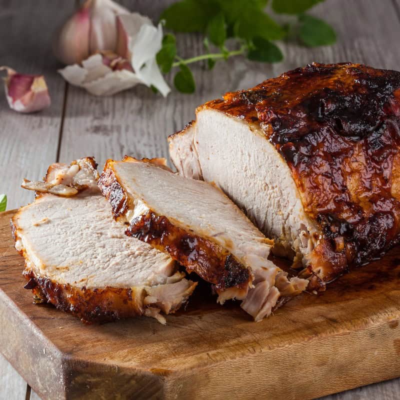 Cooked Loin of Pork on a wooden board