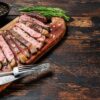 Cooked steak served on a wooden board