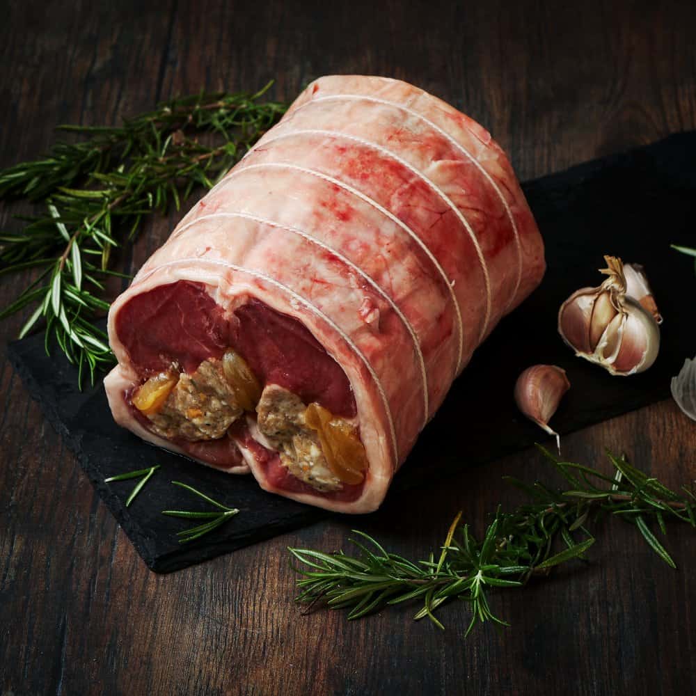 Photo of Owton Stuffed Lamb Saddle on a chalkboard, taken from the front to see the stuffing