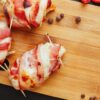 Crispy Bacon wrapped in chicken on a wooden board